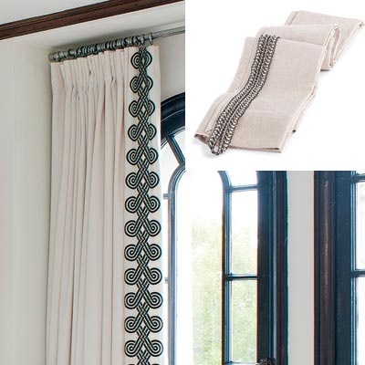 Braid trimmed curtains hung on a pole in front of the window can be used to dress awkwardly shaped windows like these arched ones. 