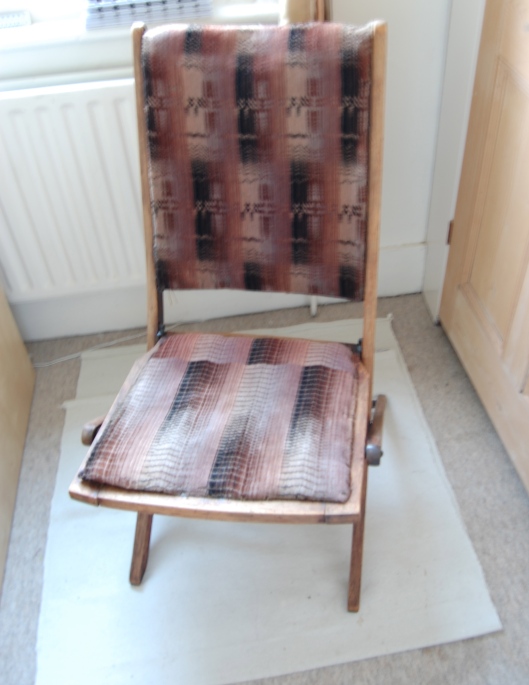 Original seat with upholstery probably dating from the 1950s.